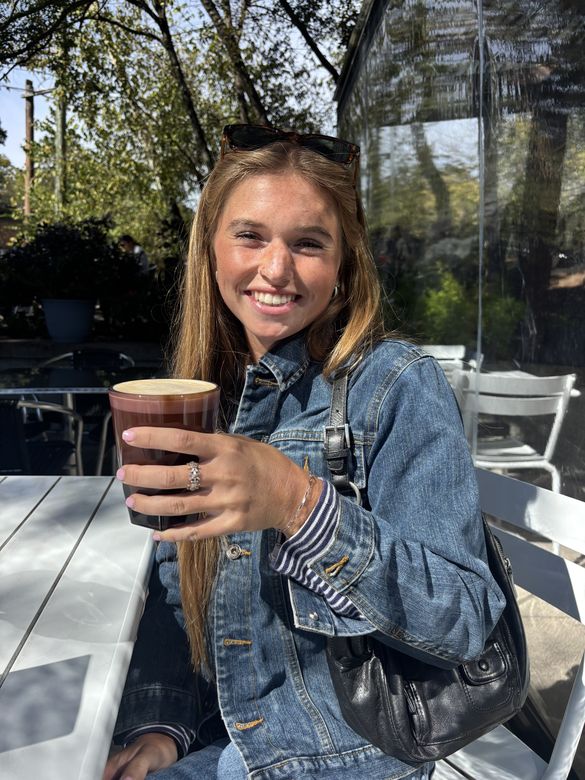 Ria smiling at a cafe table